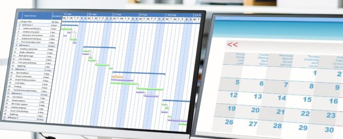 Person using dual monitors displaying a Gantt chart and calendar, possibly planning for a grant writing project timeline.